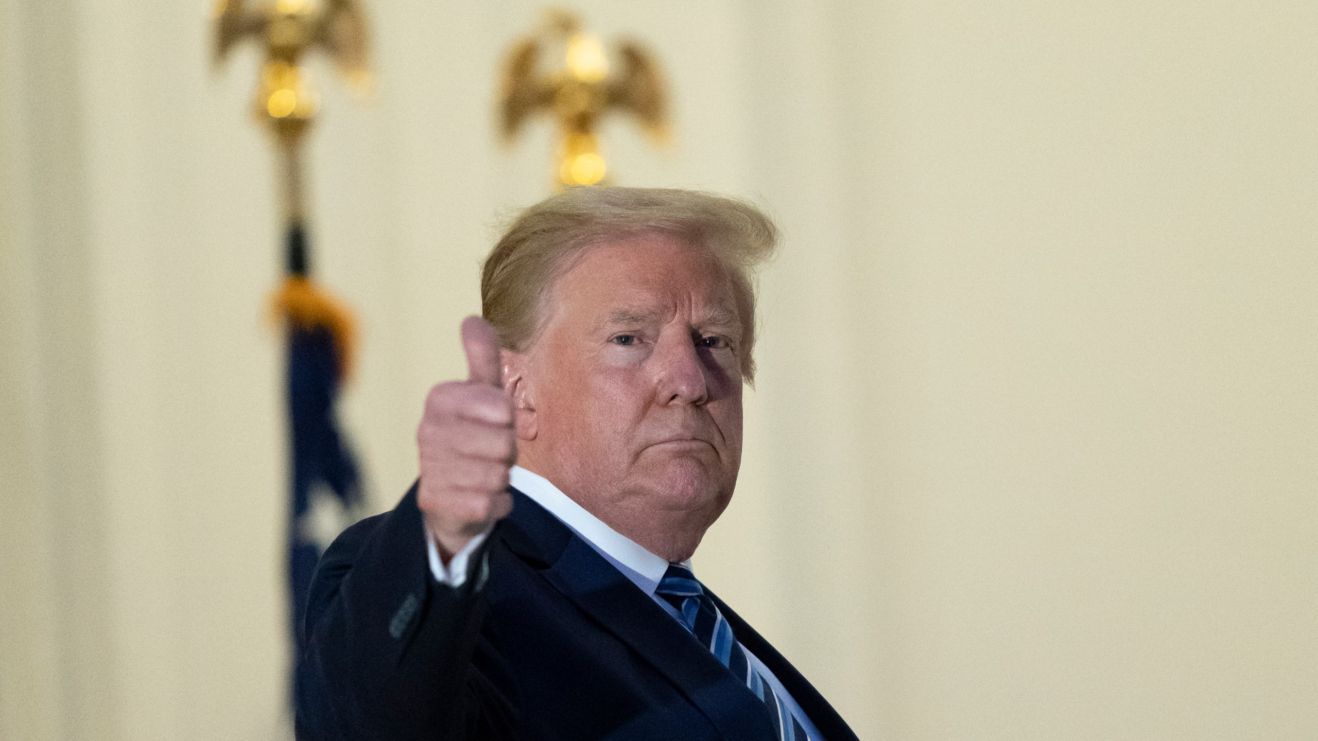 President Donald Trump gives thumbs up from the Blue Room Balcony upon returning to the White House Monday, Oct. 5, 2020, in Washington, after leaving Walter Reed National Military Medical Center, in Bethesda, Md. Trump announced he tested positive for COVID-19 on Oct. 2. (AP Photo/Alex Brandon)