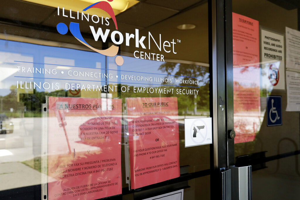 In this June 11, 2020, file photo, information signs are displayed at the closed Illinois Department of Employment Security WorkNet center in Arlington Heights, Ill. (AP Photo/Nam Y. Huh, File)