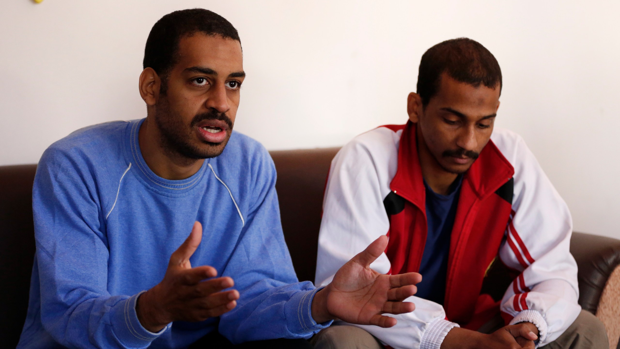 In this March 30, 2019, file photo, Alexanda Amon Kotey, left, and El Shafee Elsheikh, who were allegedly among four British jihadis who made up a brutal Islamic State cell dubbed "The Beatles," speak during an interview with The Associated Press at a security center in Kobani, Syria. The Justice Department is preparing to announce charges Wednesday against two men from Britain who joined the Islamic State and were part of a cell that beheaded Western hostages, a law enforcement official said. Their arrival in the U.S. to face charges sets the stage for arguably the most sensational terrorism prosecution since the 2014 case against the suspected ringleader of a deadly attack on the diplomatic compound in Benghazi, Libya.(AP Photo/Hussein Malla, File)