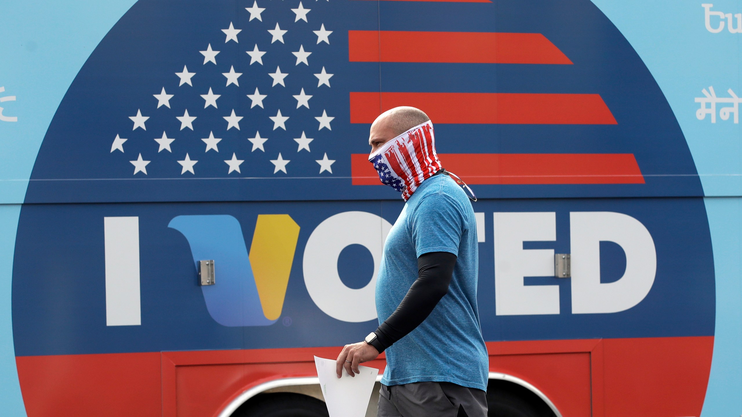 In this May 12, 2020 file photo, Robb Rehfeld wears a mask as he walks to cast his vote during a special election for California's 25th Congressional District seat in Santa Clarita, Calif. (AP Photo/Marcio Jose Sanchez, File)