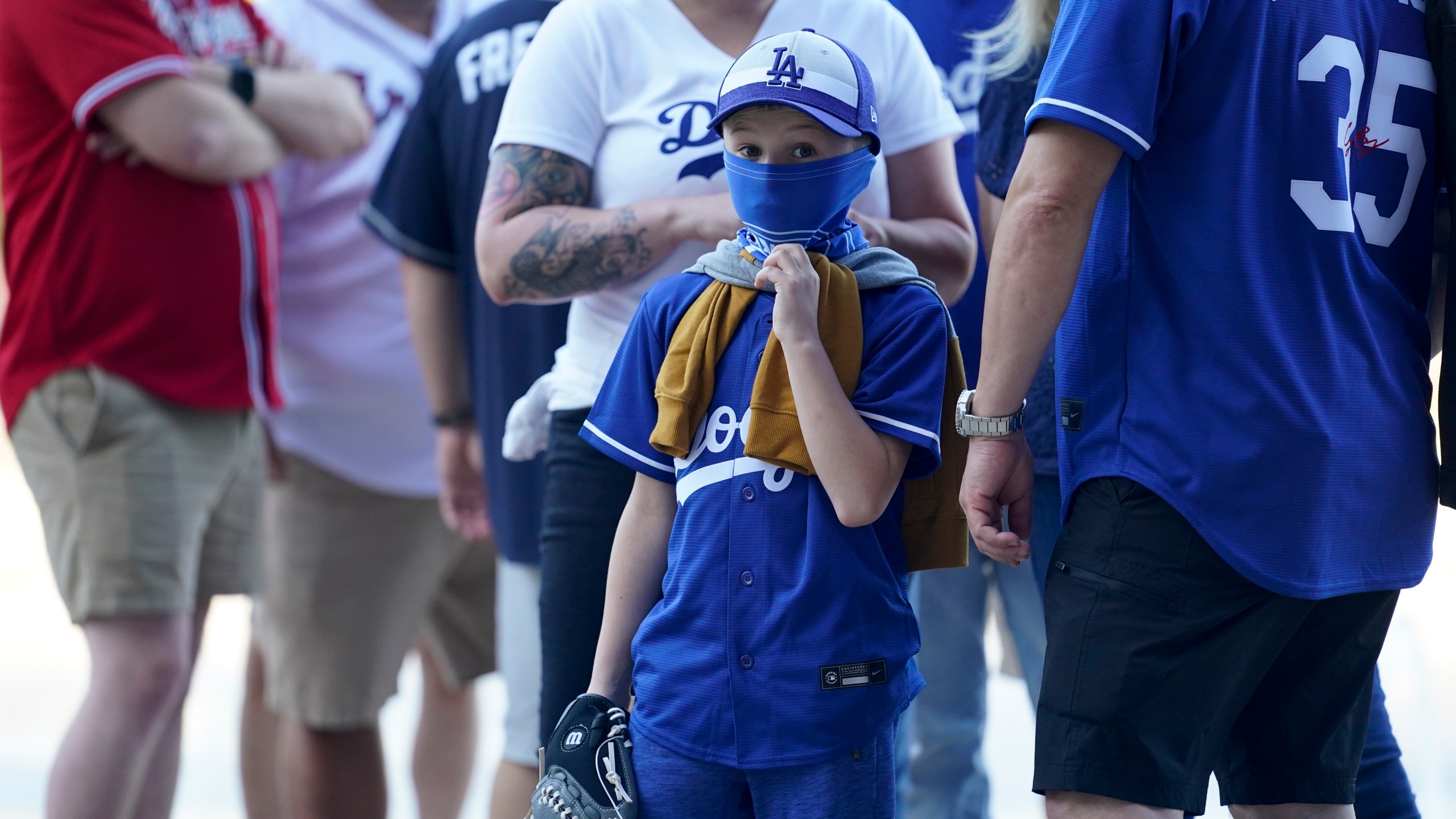 Fans arrive before Game 1 of a baseball National League Championship Series between the Los Angeles Dodgers and the Atlanta Braves on, Oct. 12, 2020, in Arlington, Texas. (AP Photo/Eric Gay)