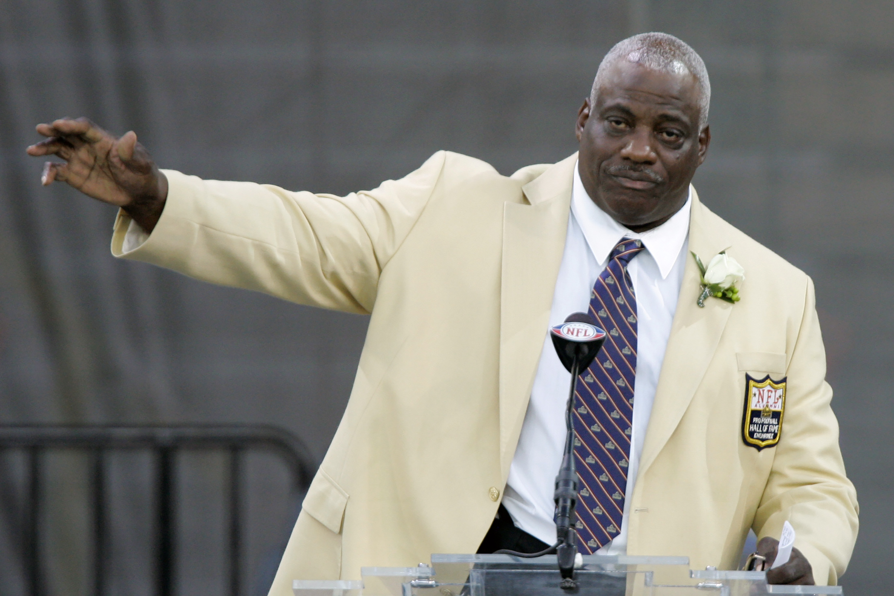 In this Aug. 2, 2008, file photo, former San Diego Chargers defensive end Fred Dean waves to fans after his speech at the Pro Football Hall of Fame, in Canton, Ohio. Dean, the fearsome pass rusher who was a key part of the launch of the San Francisco 49ers' dynasty, has died. (Mark Duncan/Associated Press)