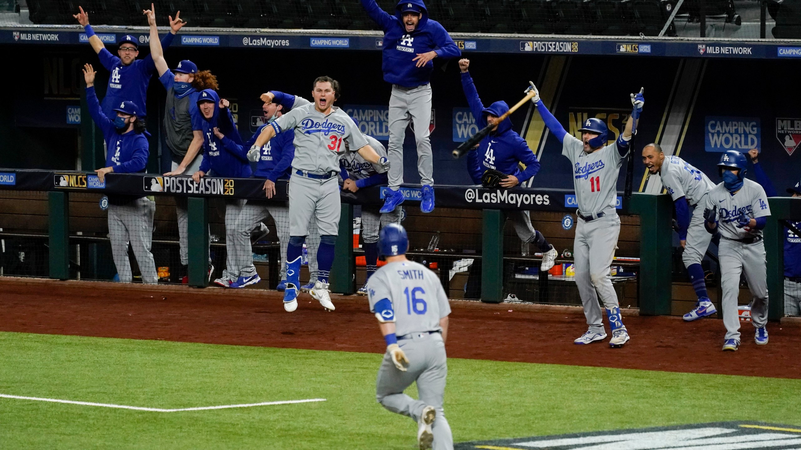 The Los Angeles Dodgers celebrate a three-run home run by Will Smith against the Atlanta Braves during the sixth inning in Game 5 of a baseball National League Championship Series on Oct. 16, 2020, in Arlington, Texas. (AP Photo/Tony Gutierrez)