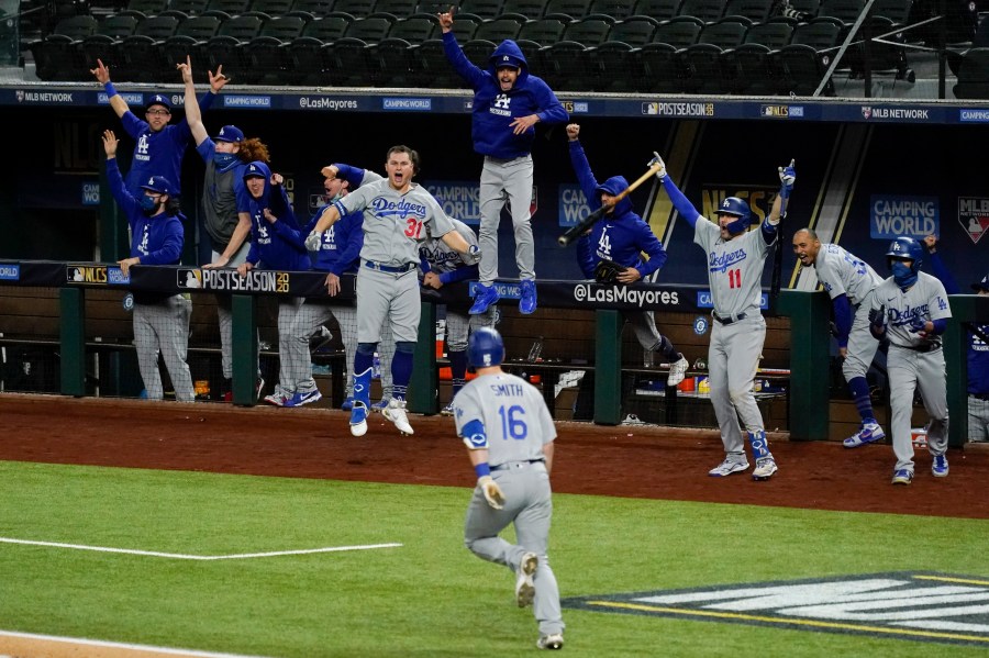 The Los Angeles Dodgers celebrate a three-run home run by Will Smith against the Atlanta Braves during the sixth inning in Game 5 of a baseball National League Championship Series on Oct. 16, 2020, in Arlington, Texas. (AP Photo/Tony Gutierrez)