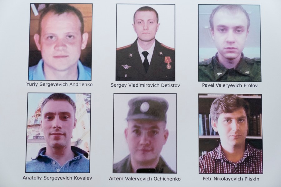 A poster showing six wanted Russian military intelligence officers is displayed before a news conference at the Department of Justice, Monday, Oct. 19, 2020, in Washington. (Andrew Harnik/AP Photo)