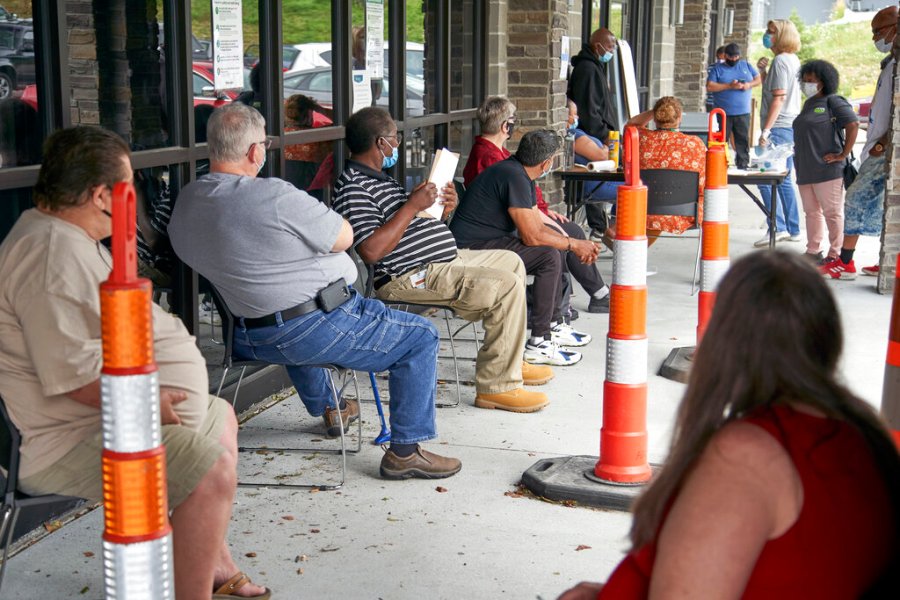 In this July 15, 2020, file photo, job seekers exercise social distancing as they wait to be called into the Heartland Workforce Solutions office in Omaha, Neb. (AP Photo/Nati Harnik, File)