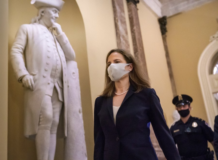 Judge Amy Coney Barrett, President Donald Trump's nominee for the Supreme Court, arrives for closed meetings with senators, at the Capitol in Washington, Wednesday, Oct. 21, 2020. (AP Photo/J. Scott Applewhite)