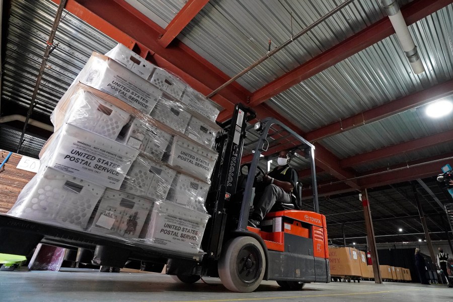 In this Sept. 3, 2020, file photo, a forklift operator loads absentee ballots for mailing at the Wake County Board of Elections as preparations for the upcoming election are ongoing in Raleigh, N.C. U.S. Postal Service records show delivery delays have persisted across the country as millions of Americans began voting by mail, raising the possibility of ballots being rejected because they arrive too late. Postal data covering the beginning of October show nearly all of the agency's delivery regions missing agency targets of having more than having more than 95% of first-class mail arrive within five days. (AP Photo/Gerry Broome, File)