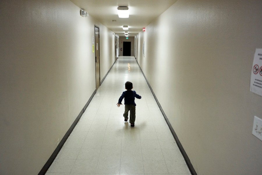 In this Dec. 11, 2018, file photo, an asylum-seeking boy from Central America runs down a hallway after arriving from an immigration detention center to a shelter in San Diego. (Gregory Bull/Associated Press)