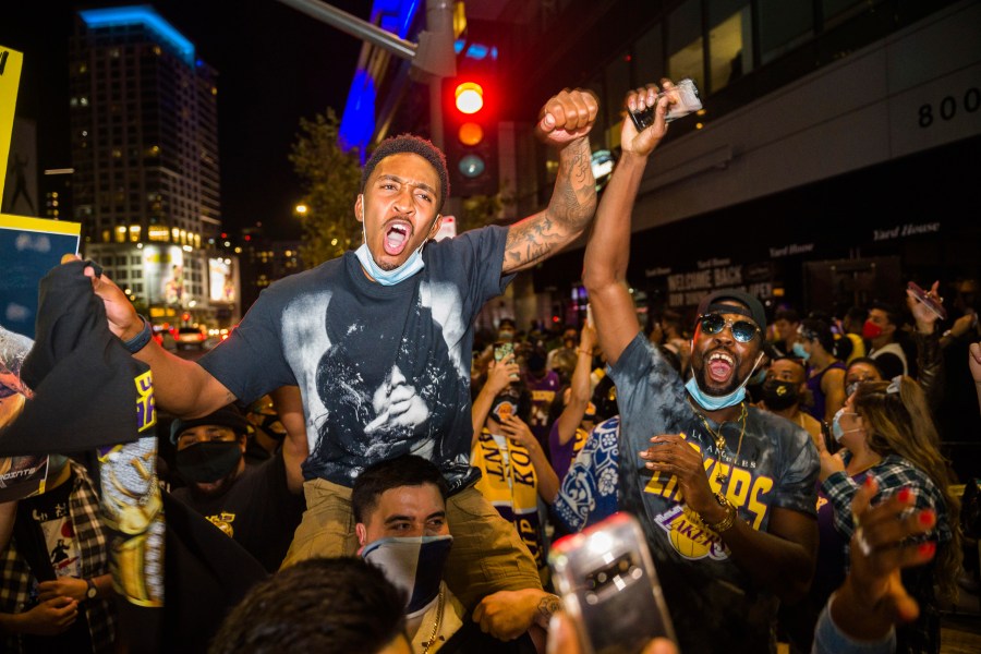 Fans in Los Angeles celebrate after the Lakers defeated the Miami Heat in Game 6 of the NBA Finals to win the championship on Oct. 11, 2020. (Jintak Han / Associated Press)