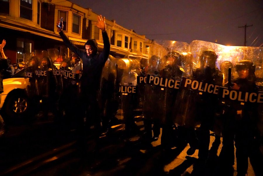 Sharif Proctor lifts his hands up in front of the police line during a protest in response to the police shooting of Walter Wallace Jr., Monday, Oct. 26, 2020, in Philadelphia. (Jessica Griffin/The Philadelphia Inquirer via AP)