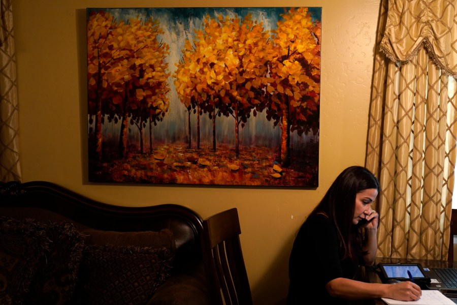 Iraqi immigrant Ethar Kakoz, a coronavirus contact tracer, makes calls Wednesday, Oct. 28, 2020, in El Cajon. (AP Photo/Gregory Bull)