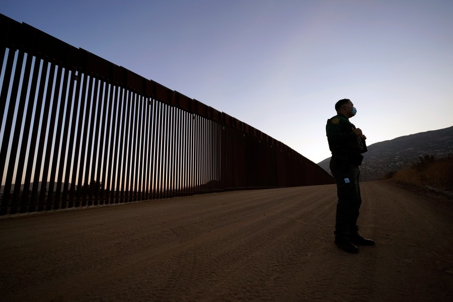 Border Patrol agent Justin Castrejon speaks in front of newly replaced border wall sections on Sept. 24, 2020, near Tecate, Calif. (AP Photo/Gregory Bull)