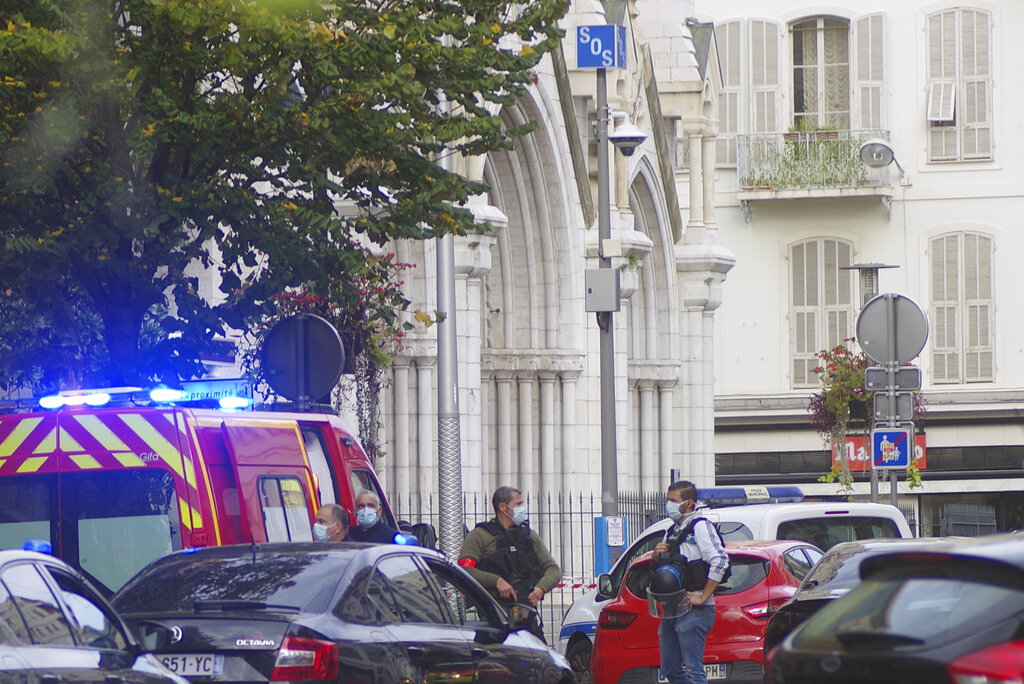 French policemen stand next to Notre Dame church after a knife attack, in Nice, France, Thursday, Oct. 29, 2020. (AP Photo/Alexis Gilli)