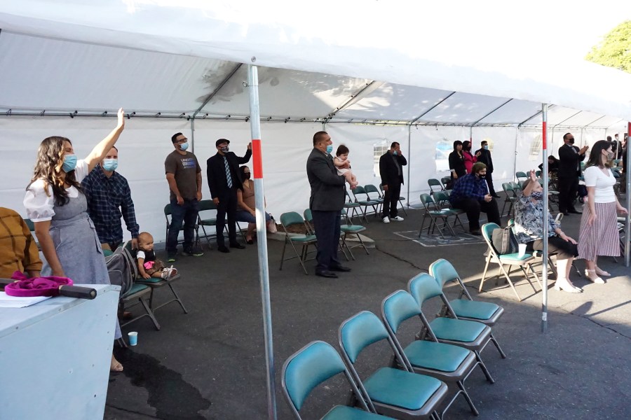 In a photo provided by Word Aflame Ministries, people are outdoors during a service at Word Aflame Tabernacle in La Habra Heights. (Word Aflame Ministries via Associated Press)