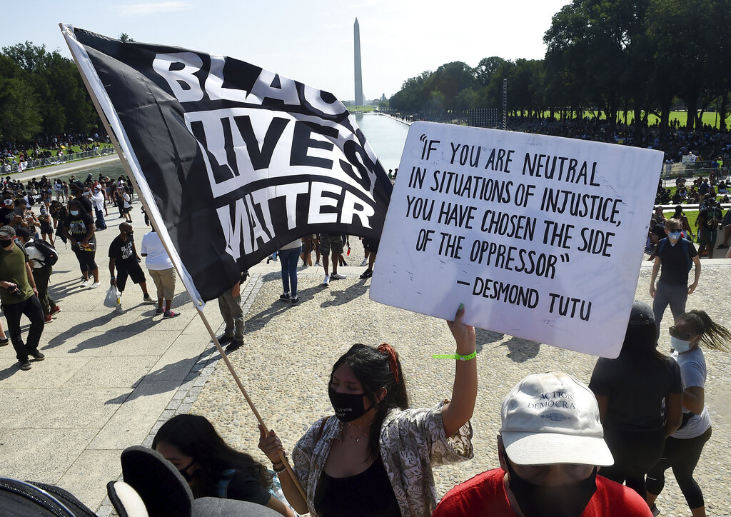 In this Aug. 28, 2020, file photo, demonstrators gather near the Lincoln Memorial as final preparations are made for the March on Washington, in Washington, on the 57th anniversary of the Rev. Martin Luther King Jr.'s "I Have A Dream" speech. Several years since its founding, BLM has evolved well beyond the initial aspirations of its early supporters. Now, its influence faces a test, as voters in the Tuesday, Nov. 3 general election choose or reject candidates who endorsed or denounced the BLM movement amid a national reckoning on race (Olivier Douliery/Pool Photo via AP, File)