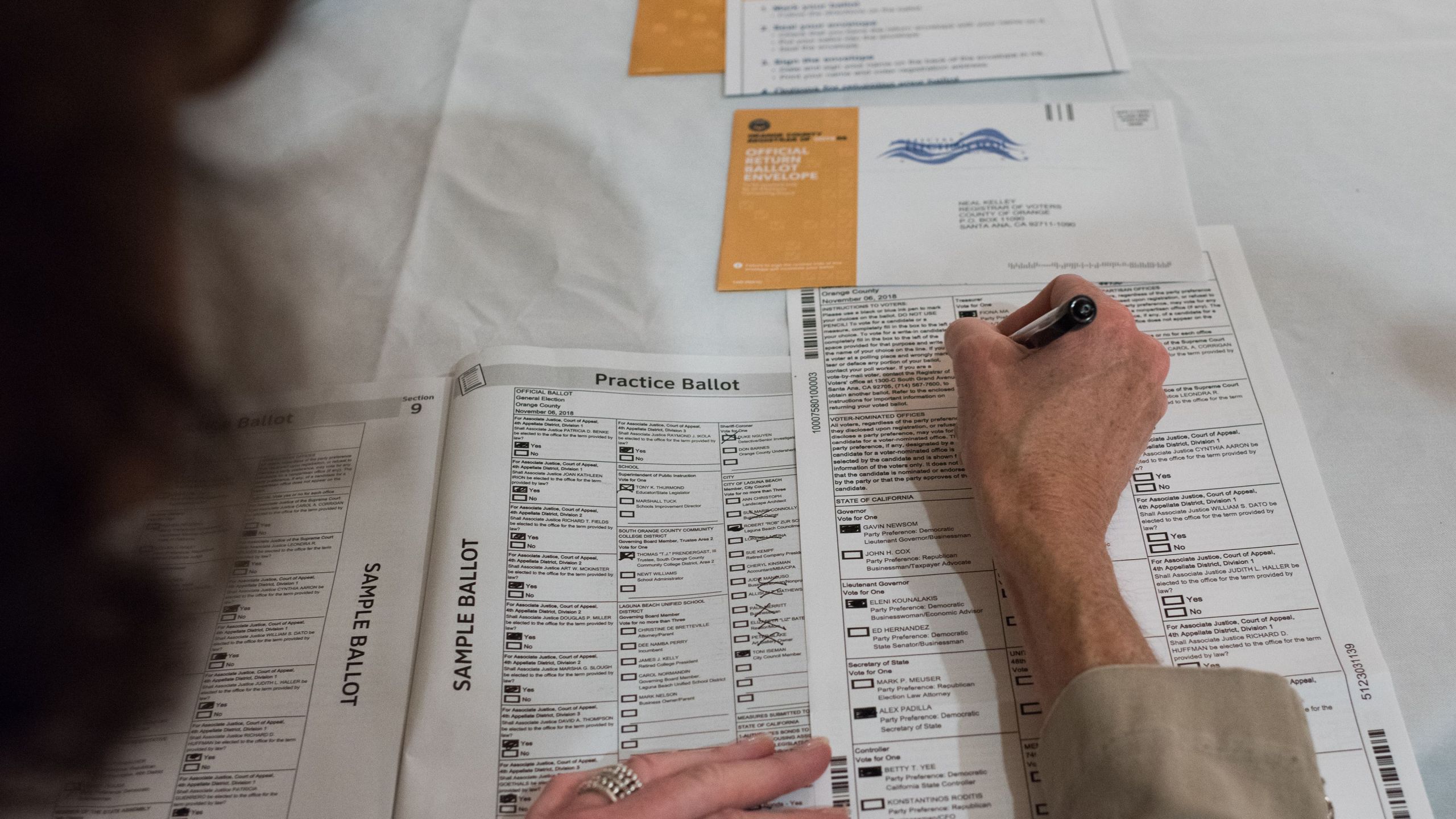 A voter completes her mail-in ballot at a ballot party at a private residence in Laguna Niguel on Oct. 24, 2018. (ROBYN BECK/AFP via Getty Images)