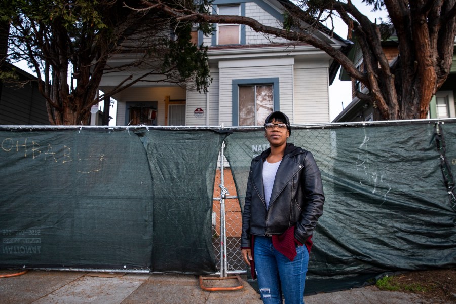 Moms 4 Housing activist Misty Cross stands for a portrait in front of the fenced-off vacant home that she and other homeless or insecurely housed mothers occupied during a months-long protest which ended in a court ordered eviction, in Oakland, California on Jan. 28, 2020. (PHILIP PACHECO/AFP via Getty Images)