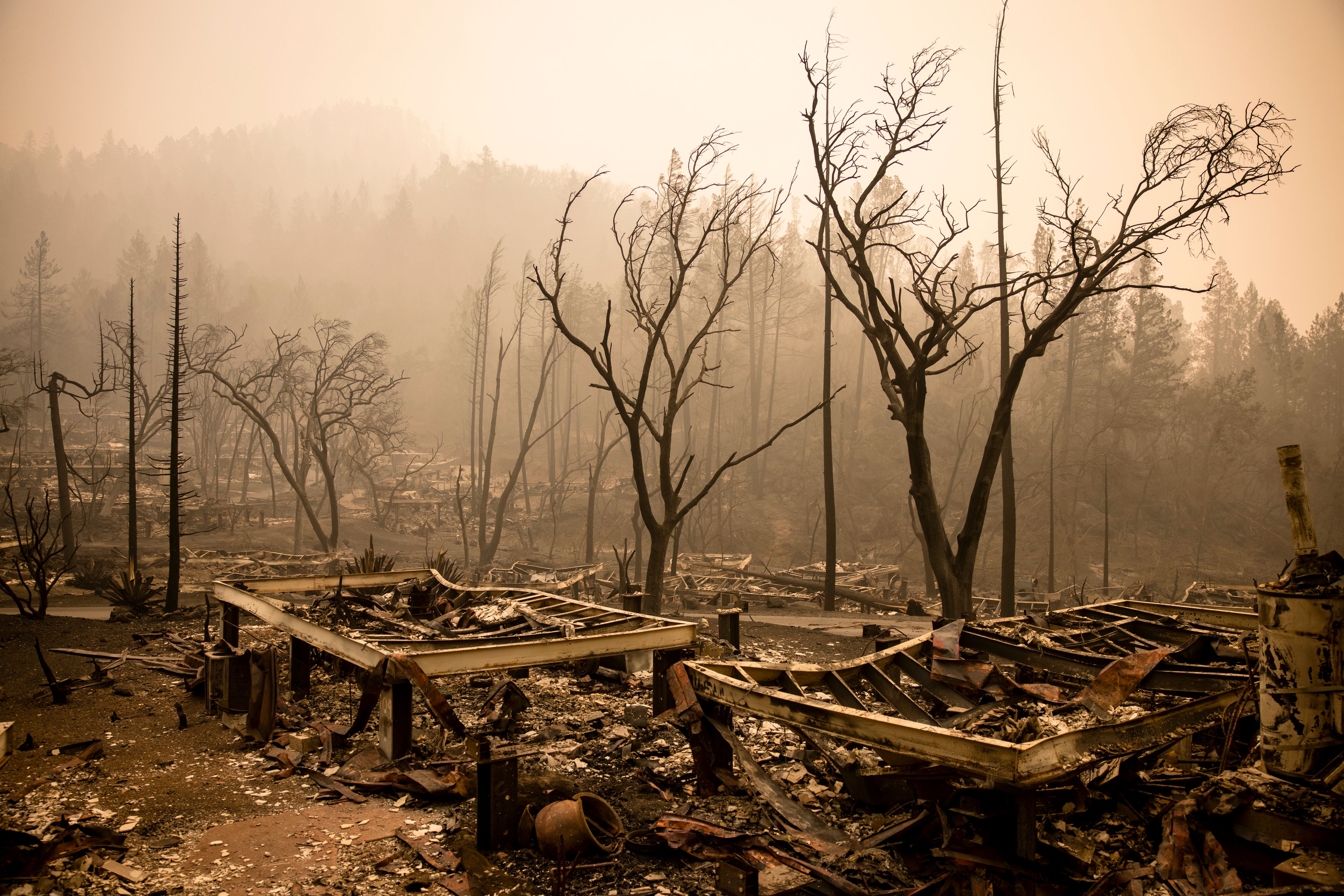 The remains of the guest houses at Calistoga Ranch smoulder after the Glass Fire passed through in, Calistoga, Napa Valley, California on Sept. 30, 2020. (SAMUEL CORUM/AFP via Getty Images)