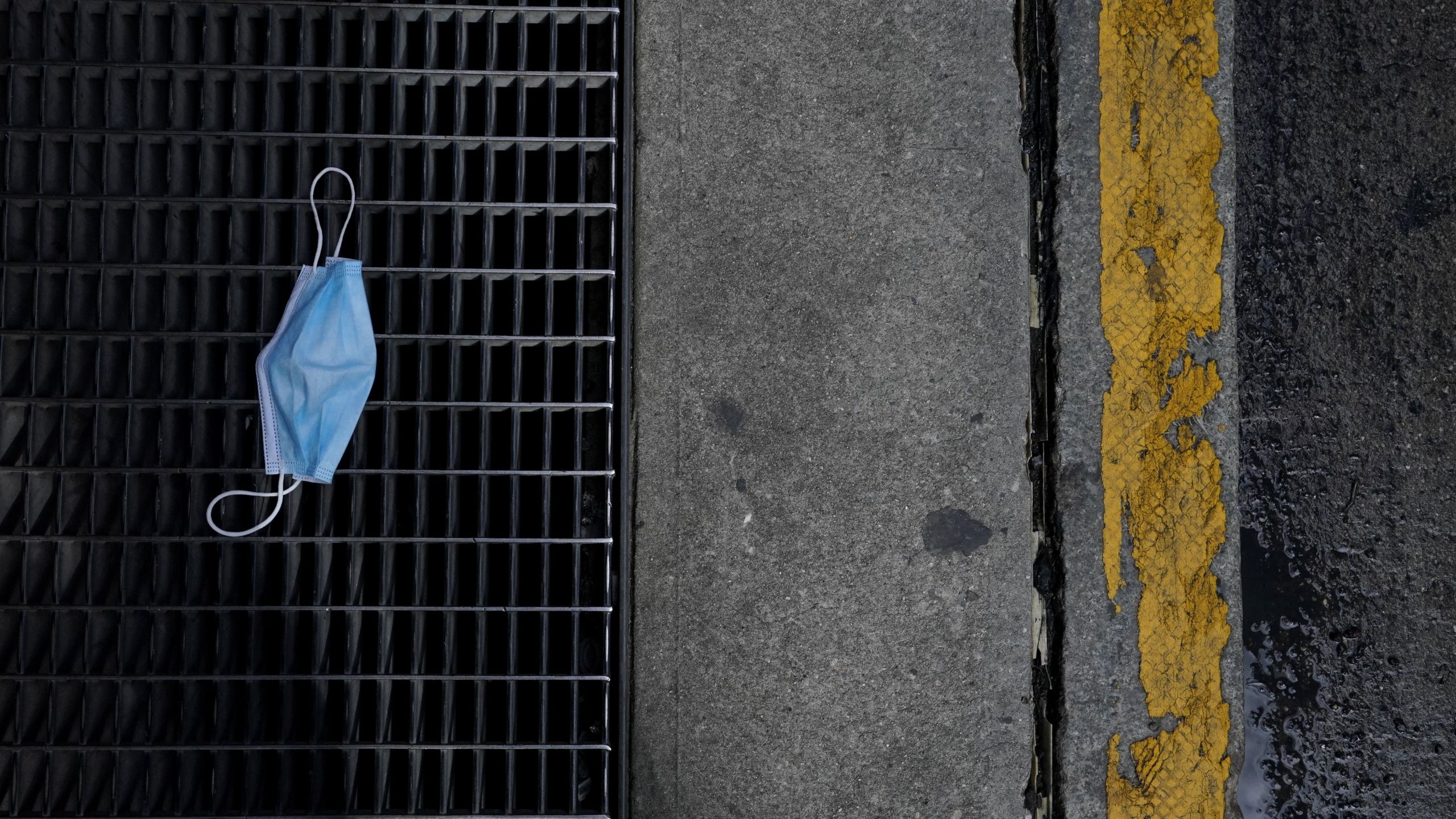 This file photo shows a discarded surgical mask on the ground of Lexington Avenue in the Upper East Side of New York on Oct. 2, 2020. (TIMOTHY A. CLARY/AFP via Getty Images)