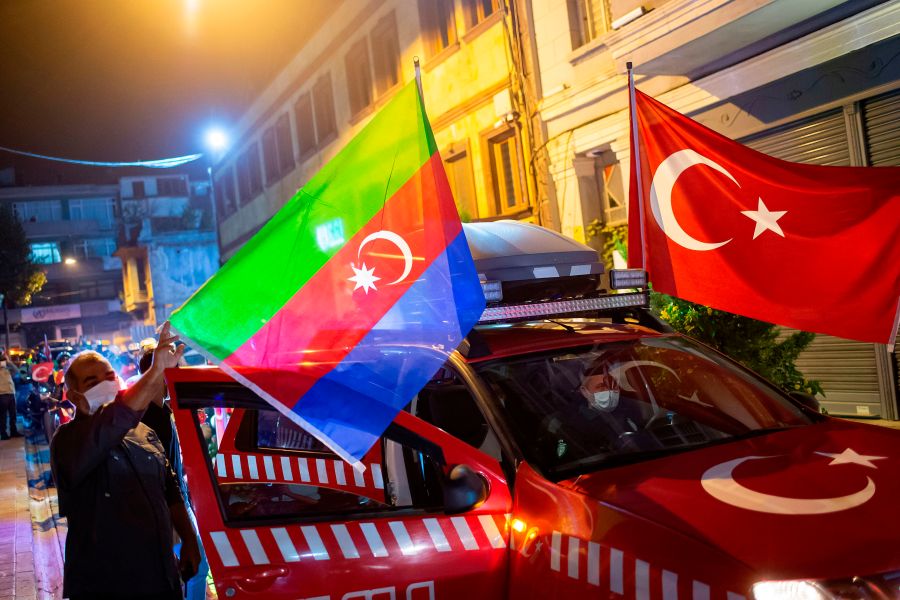 Members of Turkey's Humanitarian Relief Foundation (IHH) display Turkish and Azerbaijan flags on their vehicle before taking a tour in the city in solidarity with Azerbaijan, in Istanbul on Oct. 5, 2020. (YASIN AKGUL/AFP via Getty Images)