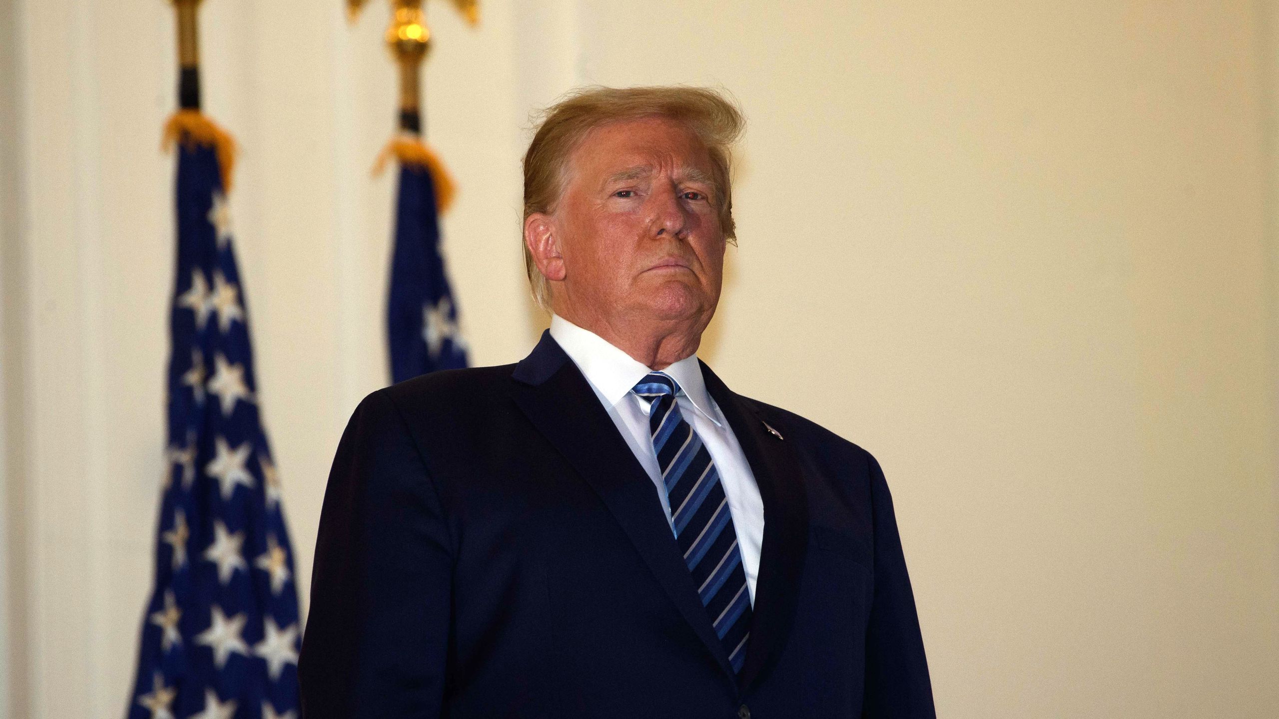 President Donald Trump looks out from the Truman Balcony upon his return to the White House from Walter Reed Medical Center, where he underwent treatment for COVID-19, in Washington, D.C., on Oct. 5, 2020. (NICHOLAS KAMM / AFP via Getty Images)