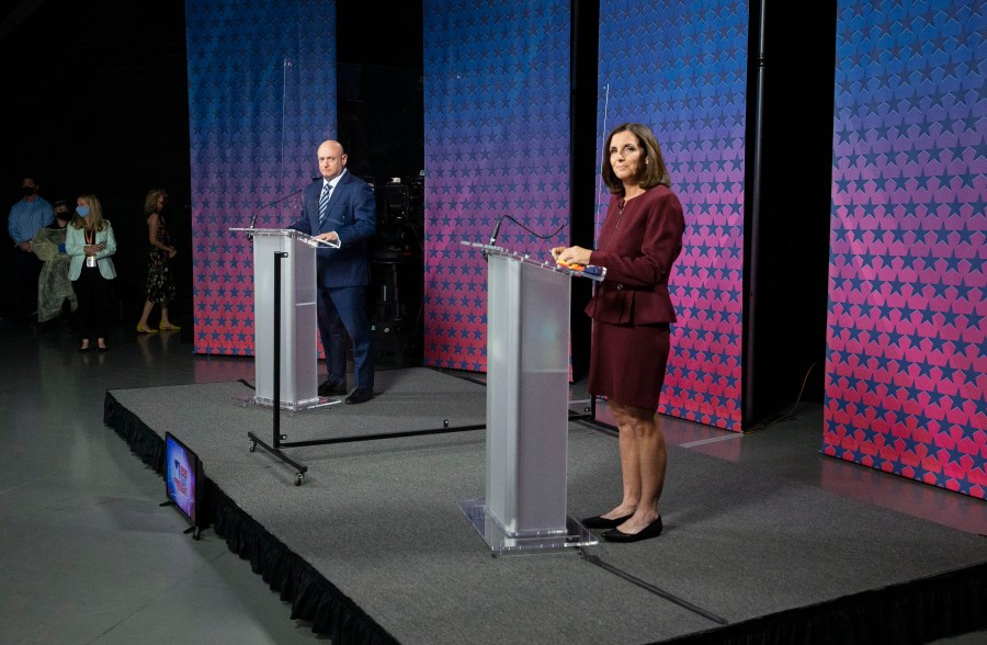 U.S. Senator Martha McSally (R-AZ) and Democratic challenger Mark Kelly are separated by plexiglass as they participate in a debate at the Walter Cronkite School of Journalism at Arizona State University in Phoenix, Arizona, on October 6, 2020. (Photo by Rob SCHUMACHER / POOL / AFP) (Photo by ROB SCHUMACHER/POOL/AFP via Getty Images)