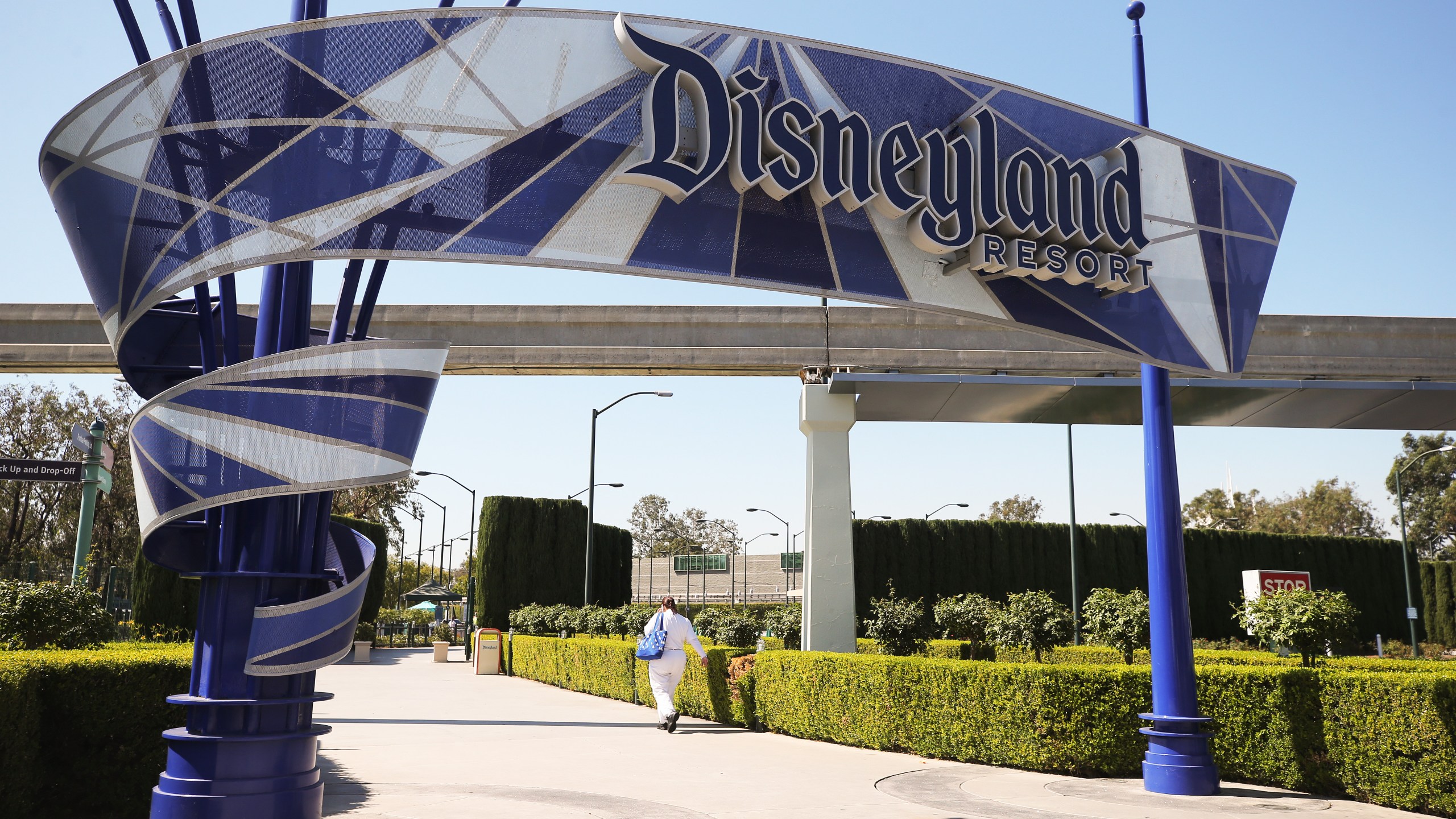 A person walks into an entrance to Disneyland in Anaheim on Sept. 30, 2020, after Disney said it was laying off 28,000 workers amid the toll of the COVID-19 pandemic on theme parks. (Mario Tama / Getty Images)