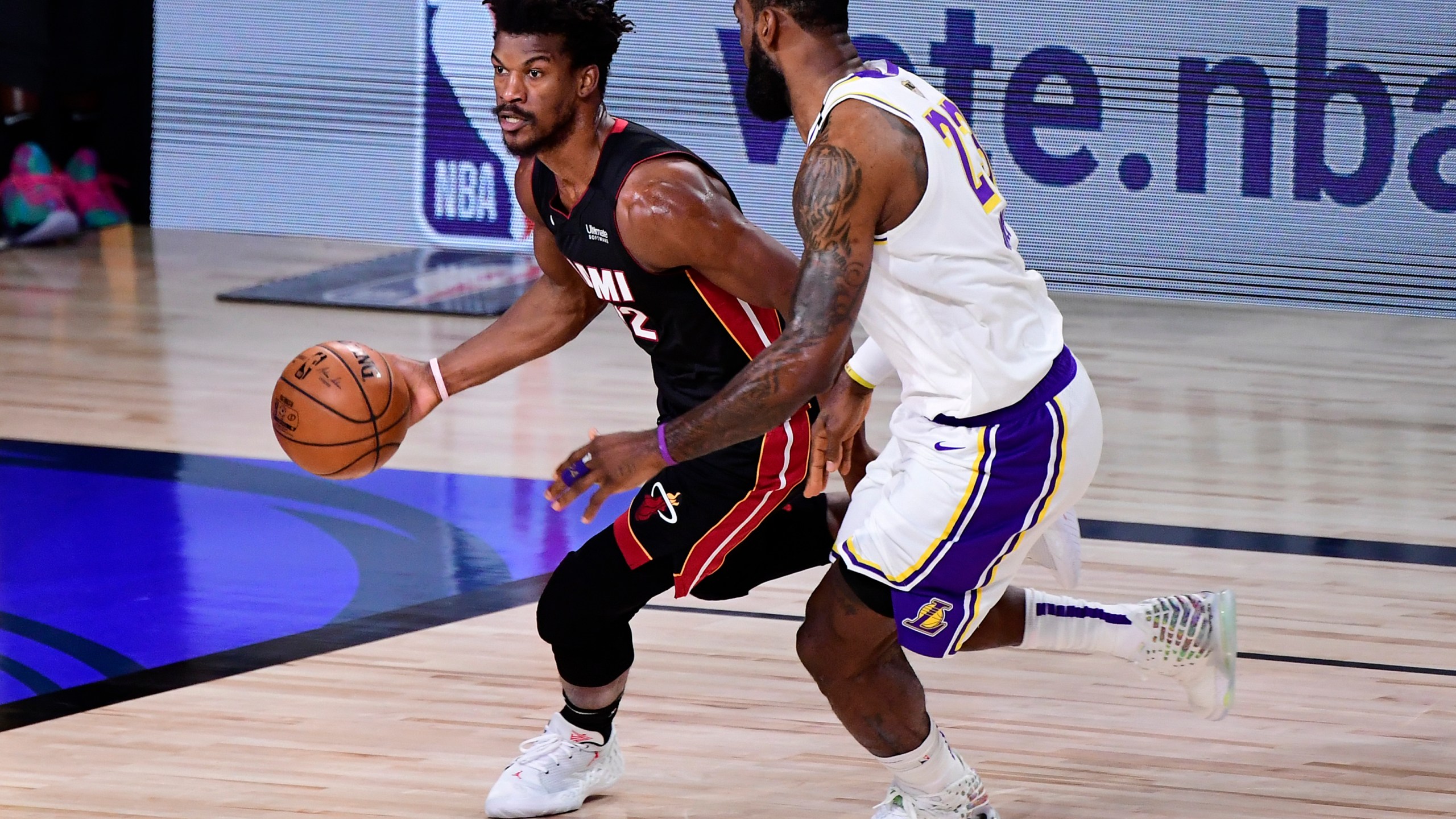 Jimmy Butler of the Miami Heat dribbles against LeBron James of the Los Angeles Lakers during the first half in Game 3 of the 2020 NBA Finals at AdventHealth Arena at ESPN Wide World Of Sports Complex on Oct. 4, 2020 in Lake Buena Vista, Florida. (Douglas P. DeFelice/Getty Images)