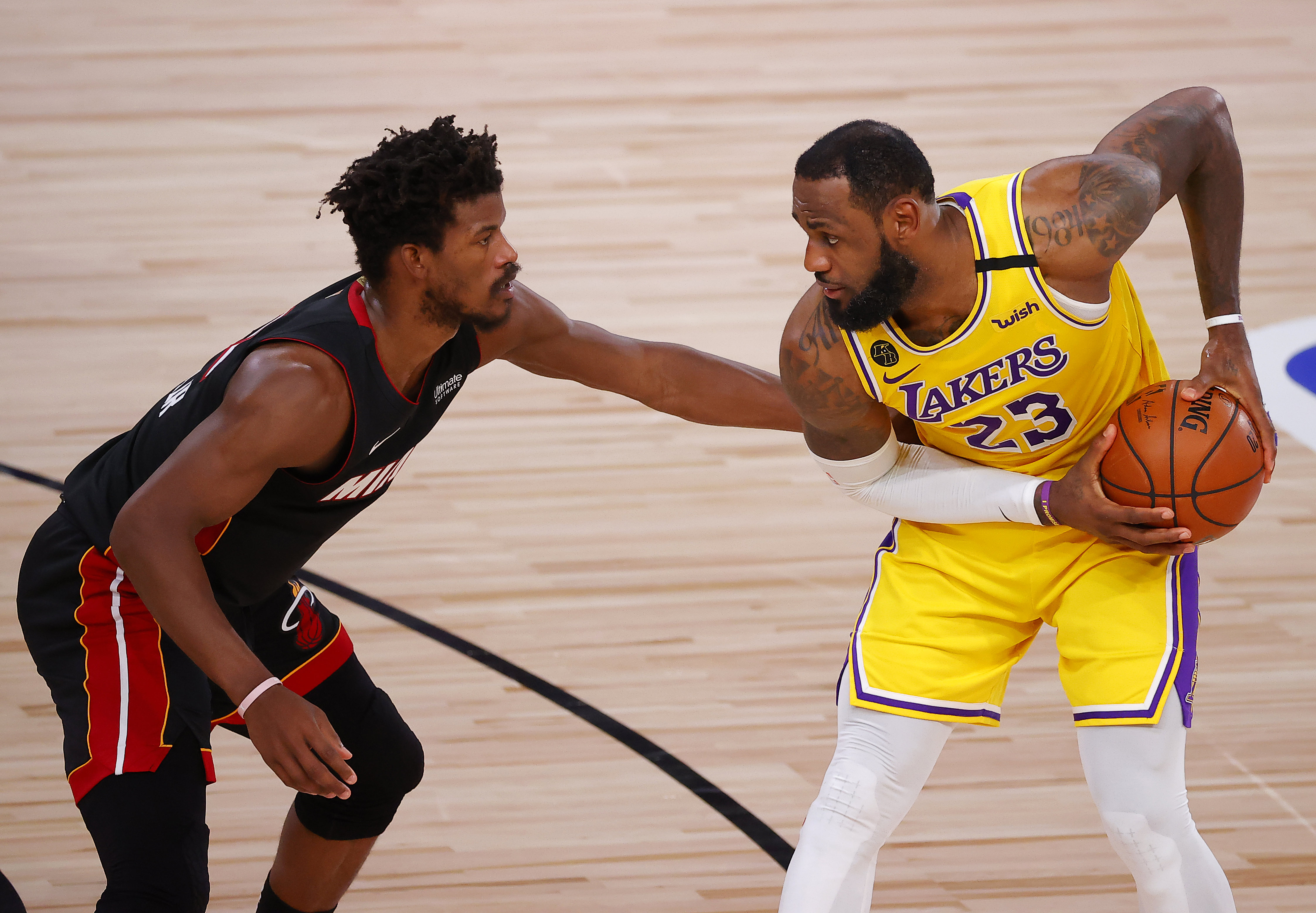 Jimmy Butler of the Miami Heat, left, defends LeBron James of the Los Angeles Lakers in Game Four of the 2020 NBA Finals in Florida on Oct. 6, 2020. (Kevin C. Cox / Getty Images)