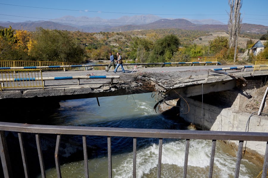 Two men walk across a bridge in Getavan, Nagorno-Karabakh, that was hit by an Azeri missile, on Oct. 14, 2020. (Alex McBride/Getty Images)