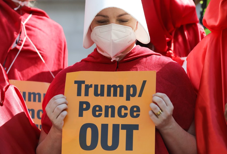 A woman in a "Handmaid's Tale" costume demonstrate during a Women’s March on Oct. 17, 2020 in Los Angeles. (Mario Tama/Getty Images)