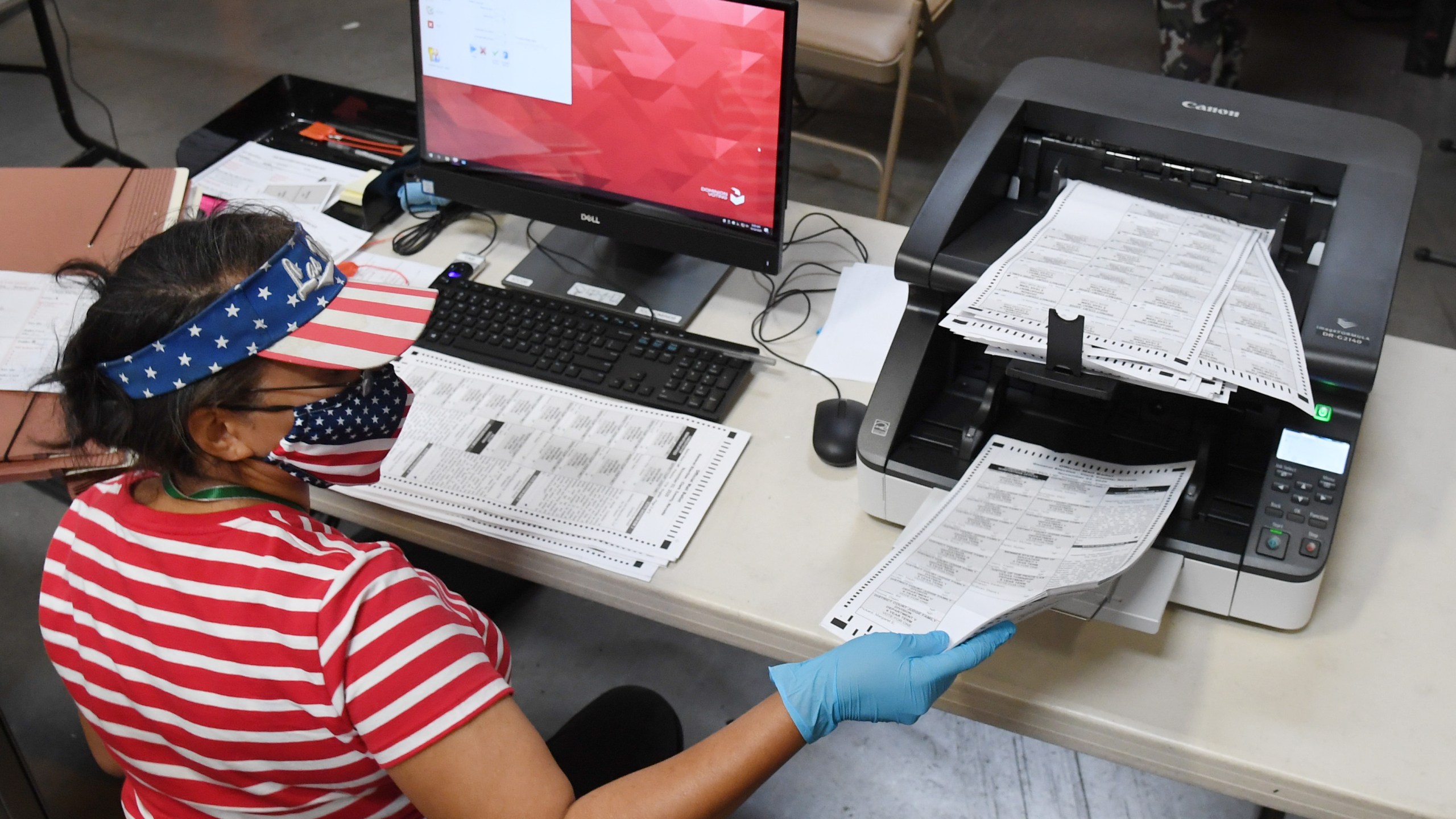 A Clark County election worker scans mail-in ballots at the Clark County Election Department on Oct. 20, 2020, in North Las Vegas, Nevada. In-person early voting for the general election in the battleground state began on Oct. 17 and continues through Oct. 30. Earlier this year, Nevada Gov. Steve Sisolak signed a bill mandating that all registered voters in the state receive a mail-in ballot for the first time to help keep people safe from the coronavirus (COVID-19). (Ethan Miller/Getty Images)