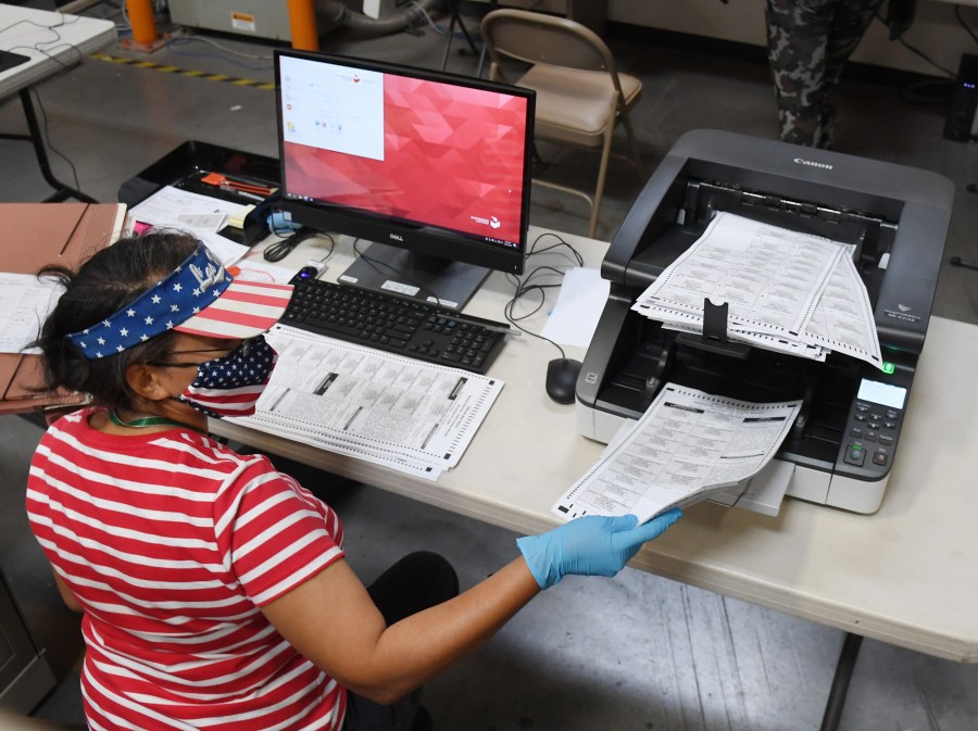 A Clark County election worker scans mail-in ballots at the Clark County Election Department on Oct. 20, 2020, in North Las Vegas, Nevada. In-person early voting for the general election in the battleground state began on Oct. 17 and continues through Oct. 30. Earlier this year, Nevada Gov. Steve Sisolak signed a bill mandating that all registered voters in the state receive a mail-in ballot for the first time to help keep people safe from the coronavirus (COVID-19). (Ethan Miller/Getty Images)