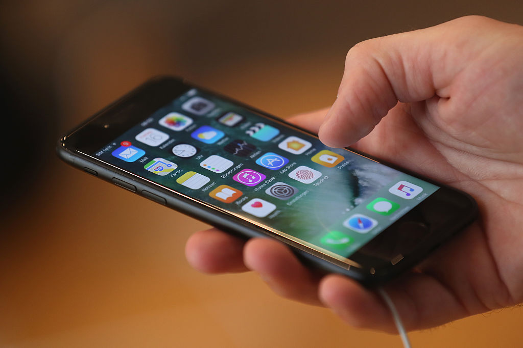 A visitor tries out an Apple iPhone 7 on the first day of sales of the new phone at the Berlin Apple store on Sept. 16, 2016 in Berlin, Germany. (Sean Gallup/Getty Images)