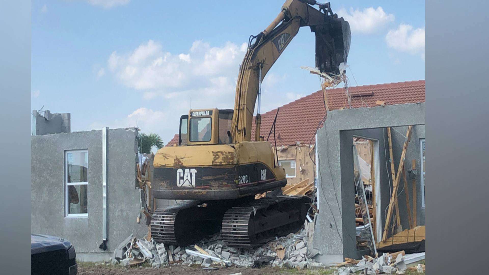 Builder Ashton Woods demolished a brand new home in Bradenton, Fla. after building it too close to the neighbor's home. (Photo courtesy: WFLA)