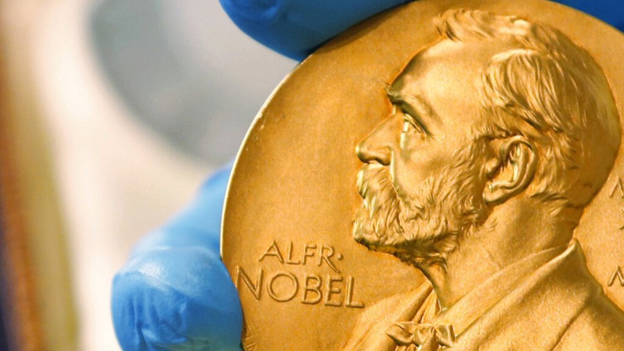 In this April 17, 2015 file photo, a national library employee shows a gold Nobel Prize medal in Bogota, Colombia. (AP Photo/Fernando Vergara, File)