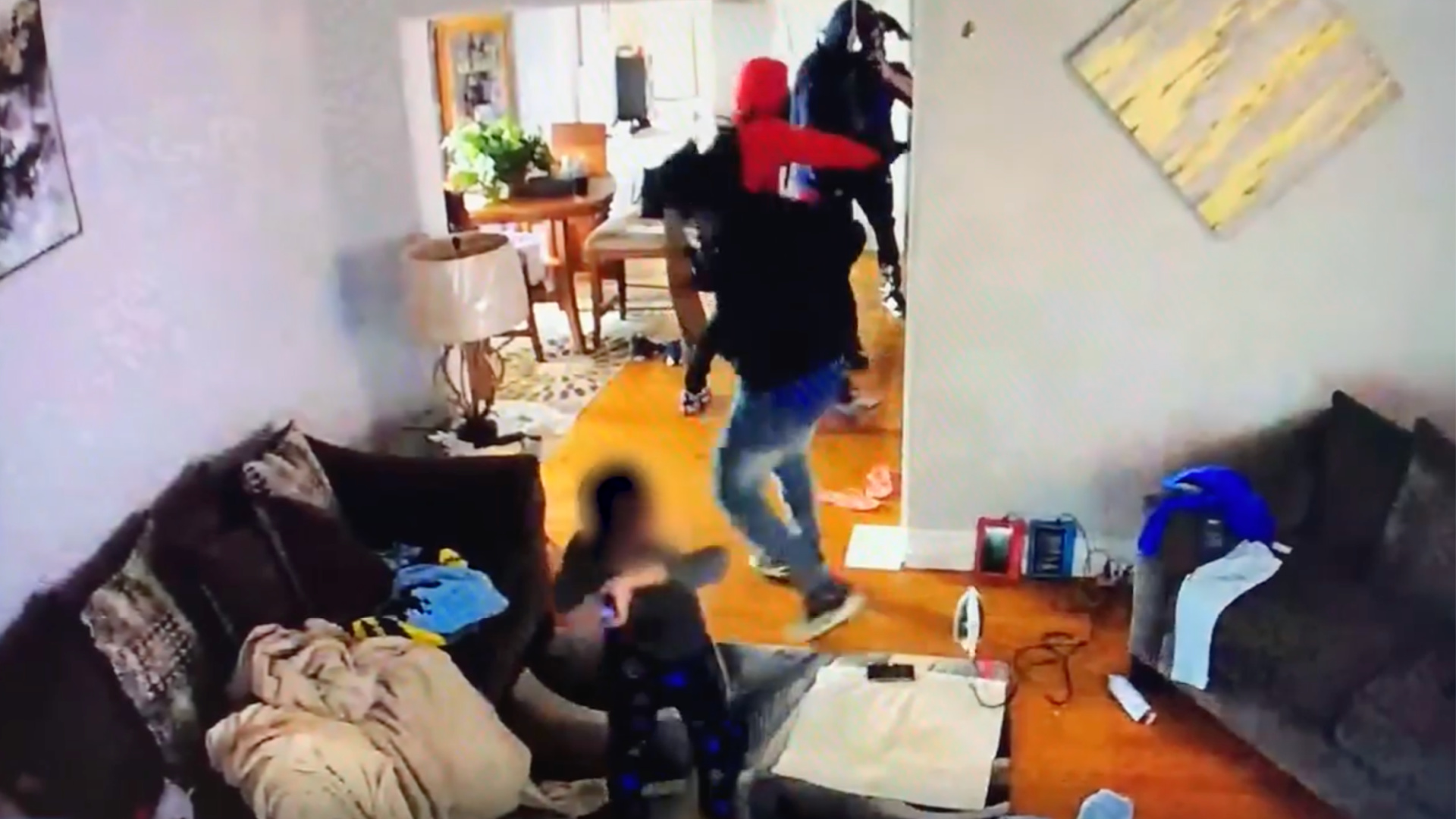 A little boy is seen hitting one of the armed gunmen during a home invasion on Sept. 30, 2020. (South Bend Police Department via Storyful)