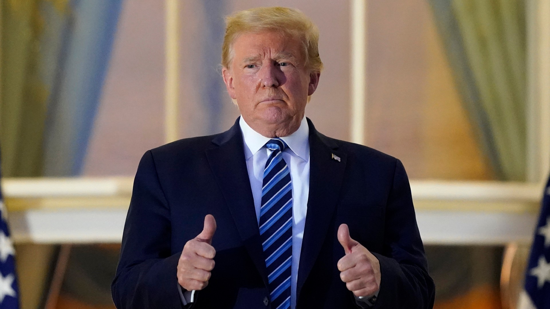 President Donald Trump stands on the balcony outside of the Blue Room as returns to the White House Monday, Oct. 5, 2020, in Washington, after leaving Walter Reed National Military Medical Center, in Bethesda, Md. Trump announced he tested positive for COVID-19 on Oct. 2. (AP Photo/Alex Brandon)