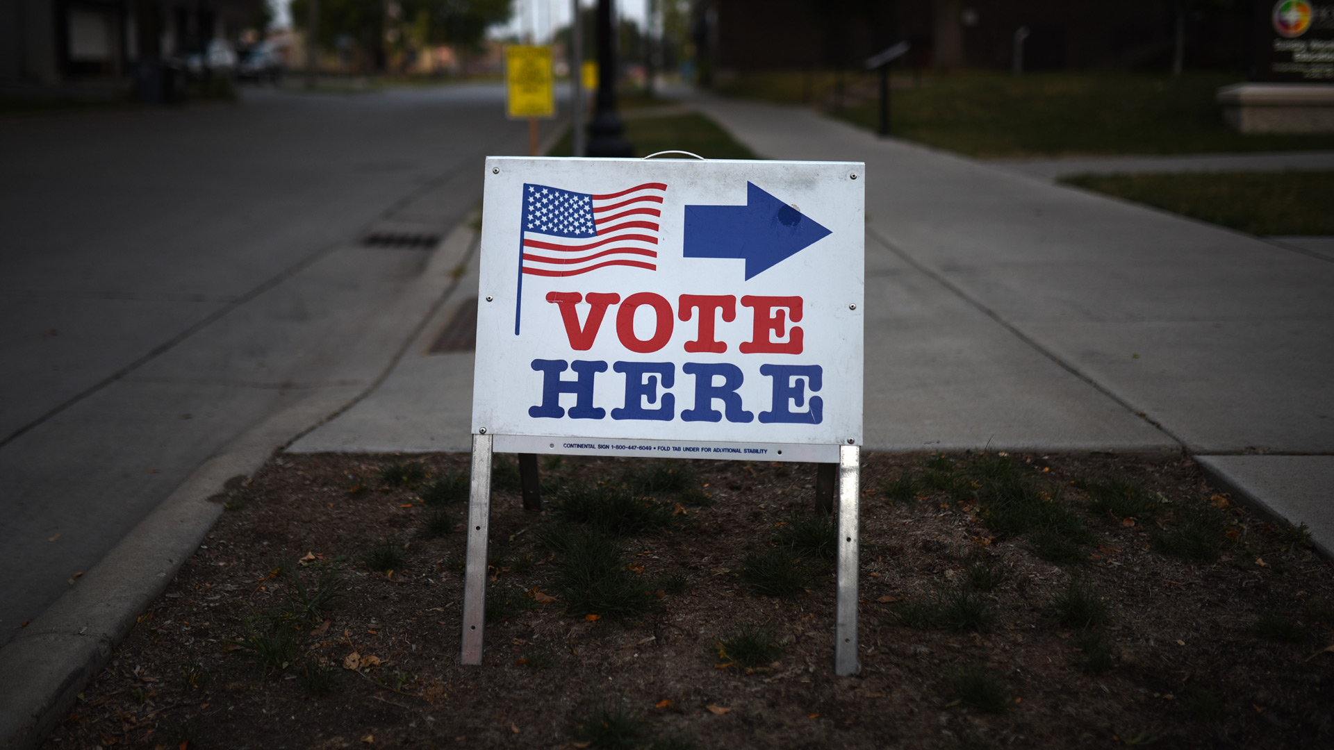 A sign reading "Vote Here" points toward a polling place in Minneapolis, Minnesota. (Stephen Maturen/Getty Images)