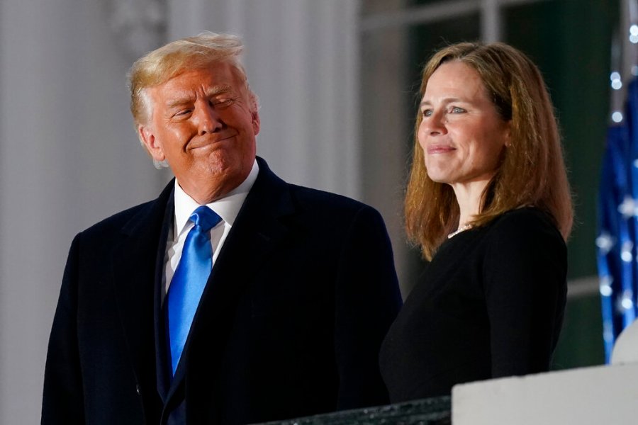 President Donald Trump and Amy Coney Barrett stand on the Blue Room Balcony after Supreme Court Justice Clarence Thomas administered the Constitutional Oath to her on the South Lawn of the White House White House in Washington on Monday. Barrett was confirmed to be a Supreme Court justice by the Senate earlier in the evening. (AP Photo/Patrick Semansky)