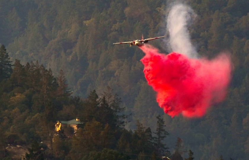 An aircraft drops fire retardant on the Glass fire in Napa County.(Kent Nishimura / Los Angeles Times)