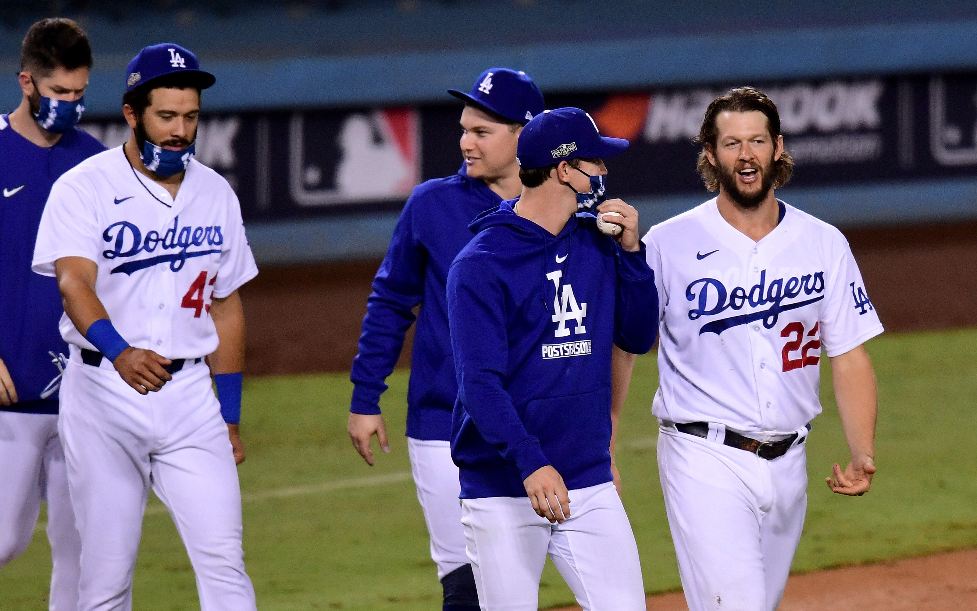 Clayton Kershaw #22 of the Los Angeles Dodgers smiles as he walks on to the field as he celebrate a 3-0 win, to eliminate the Milwaukee Brewers after game two of the National League Wild Card Series at Dodger Stadium on Oct. 1, 2020. (Harry How/Getty Images)