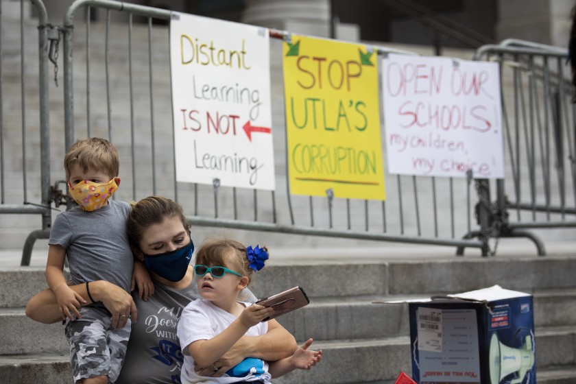 San Pedro resident Jodi Hughes and her children, ages 3 and 5, joined other families for an Open Our Schools rally at L.A. City Hall on Oct. 25, 2020. (Francine Orr / Los Angeles Times)