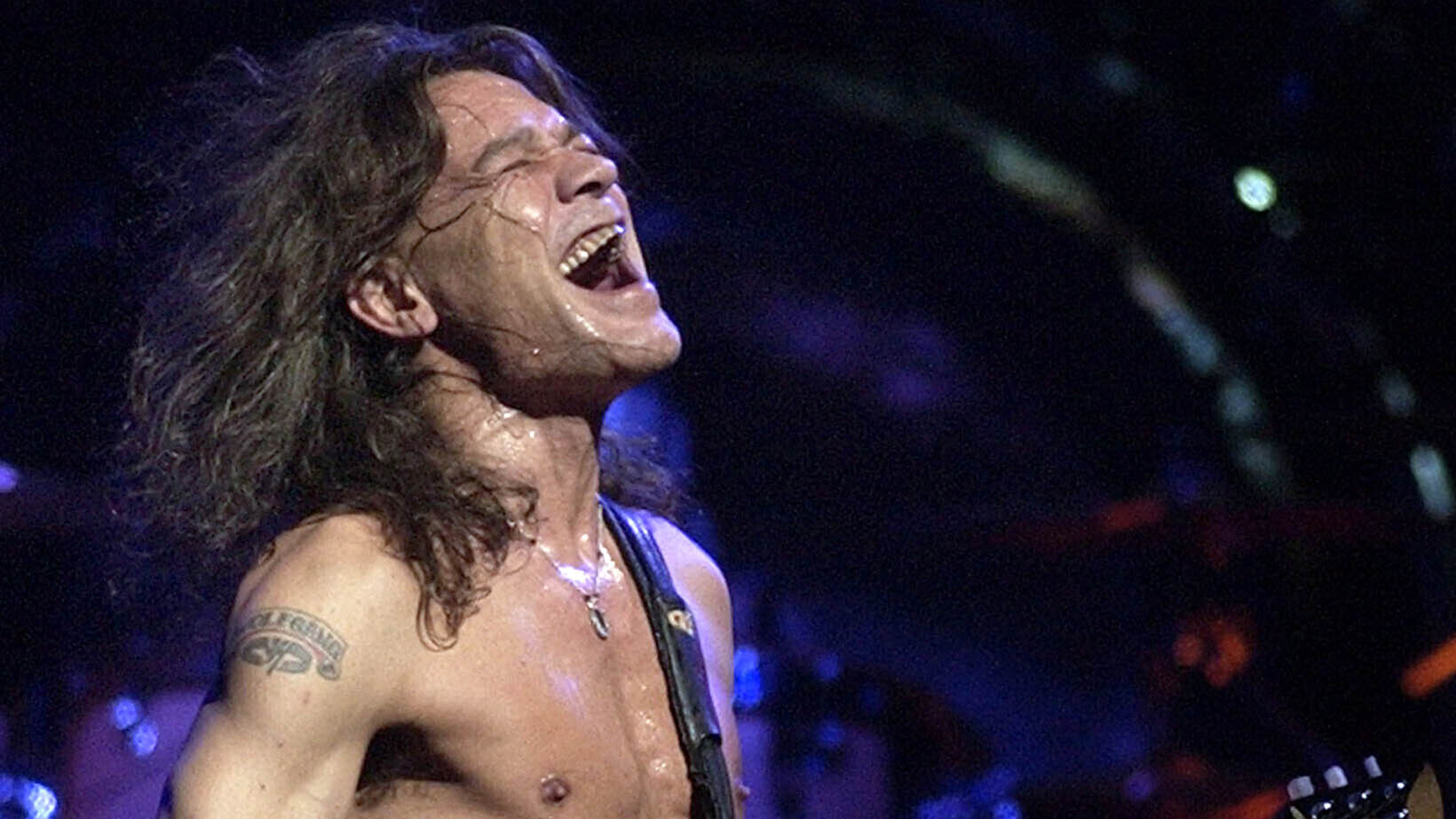 In this Aug. 5, 2004 file photo, Van Halen guitarist Eddie Van Halen performs in Phoenix. Van Halen, who had battled cancer, died Tuesday, Oct. 6, 2020. He was 65. (Tom Hood/Associated Press)