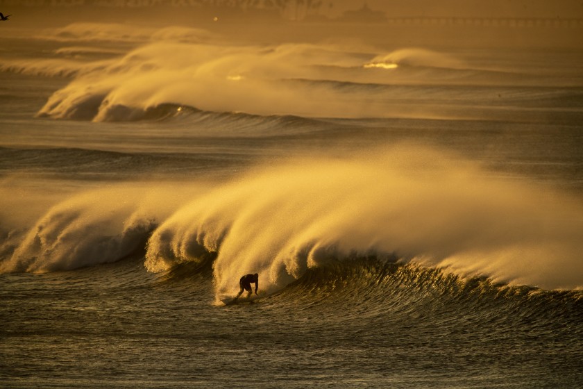 Strong Santa Ana winds blast spray from the surf off Huntington Beach in this undated photo. (Allen J. Schaben / Los Angeles Times)