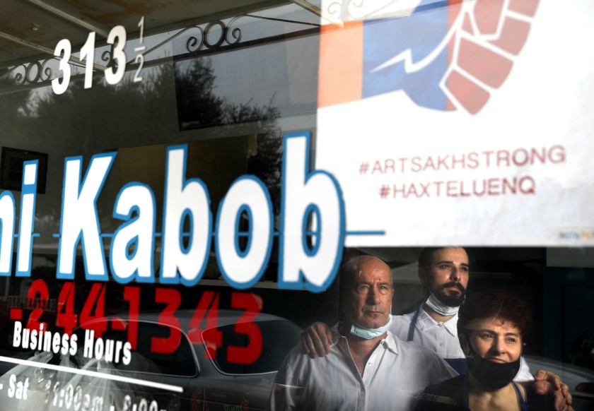 An October 2020 photo shows Armen Martirosyan, center, with his father, Hovik, and mother, Alvard. They own and operate Mini Kabob in Glendale. (Christina House / Los Angeles Times)