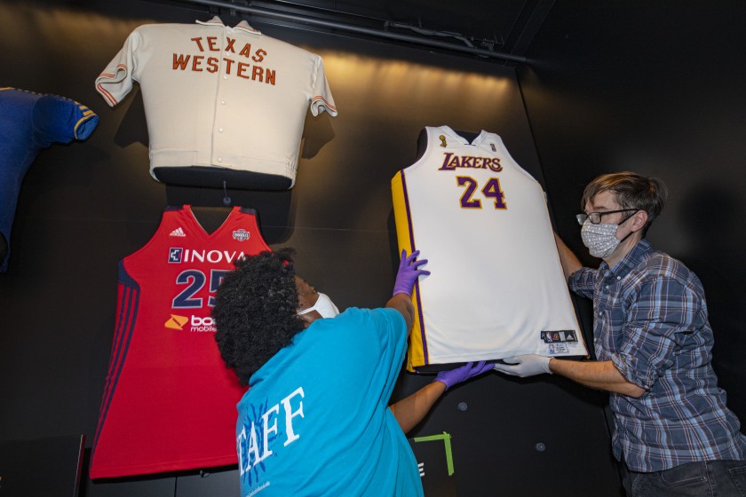 Staffers from the National Museum of African American History and Culture install a Kobe Bryant jersey in October 2020. (Robert Stewart / National Museum of African American History and Culture via Los Angeles Times)