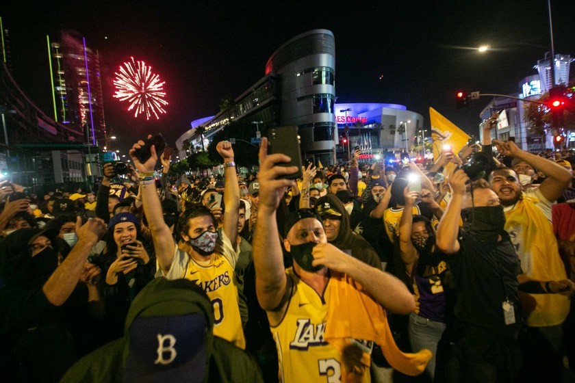 Los Angeles Lakers fans gather near Staples Center in downtown L.A. to celebrate the Lakers NBA Finals win over the Miami Heat on Oct. 11, 2020. (Jason Armond/Los Angeles Times)