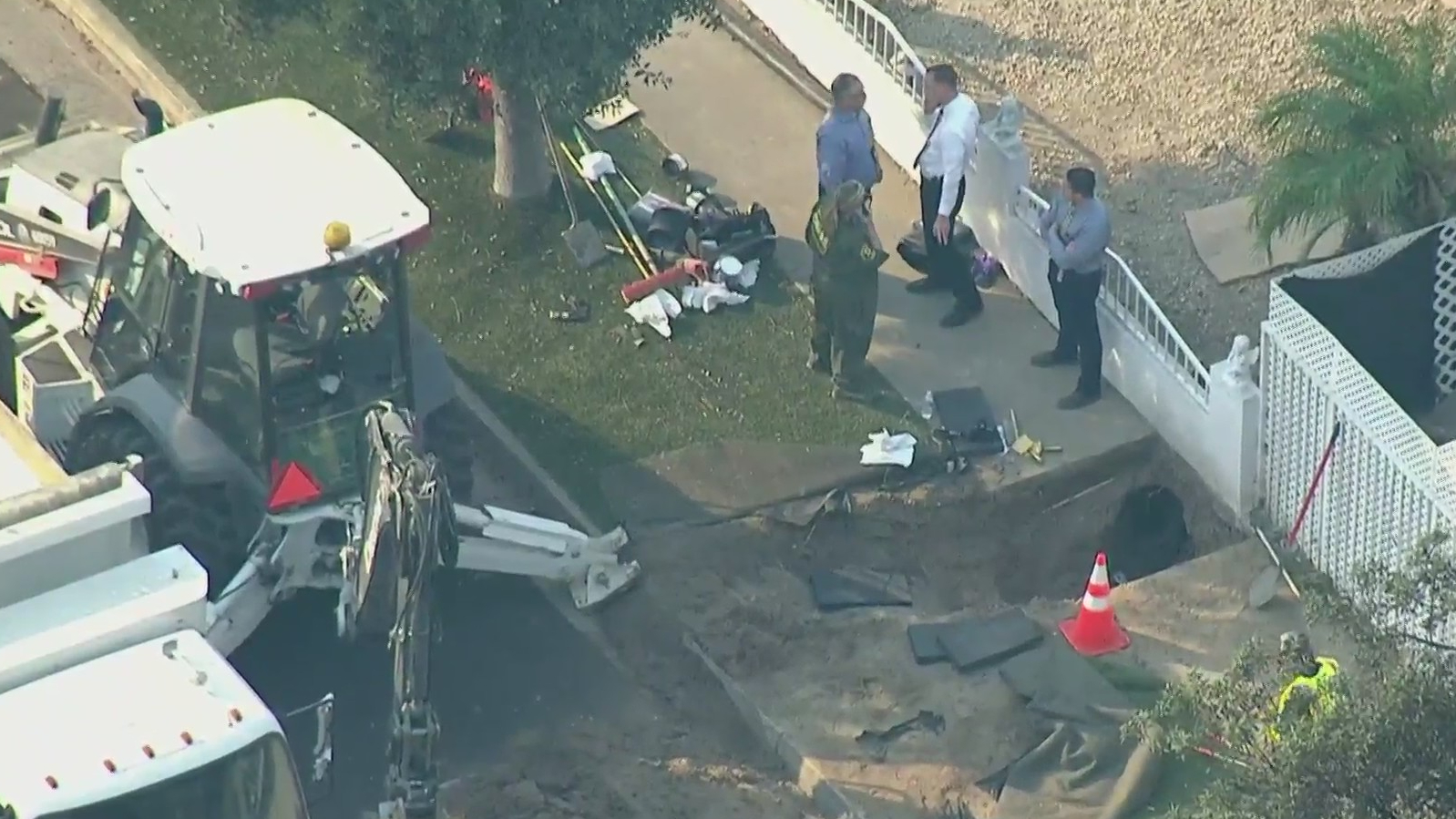 Authorities respond to investigate after human bones were found beneath a sidewalk in Santa Ana on Oct. 27, 2020. (KTLA)